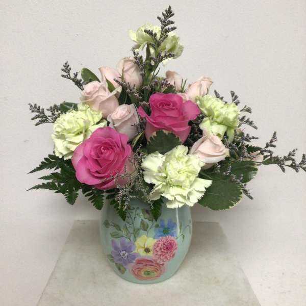 Pink and pale green roses with carnations in a painted vase