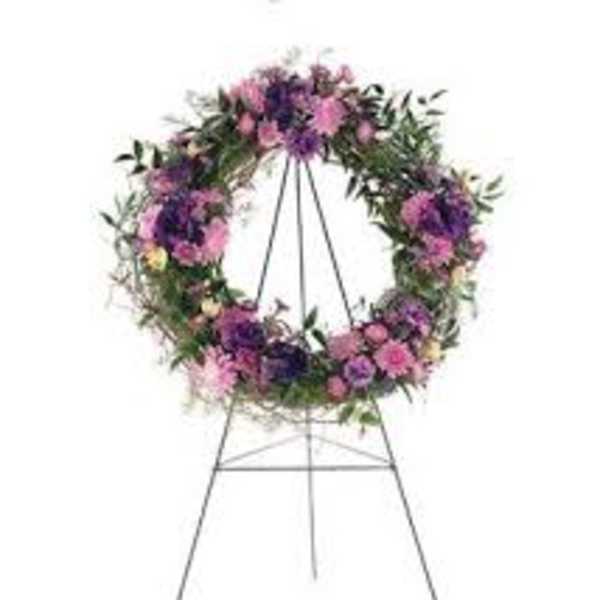 Floral wreath on a metal easel with pink and purple flowers
