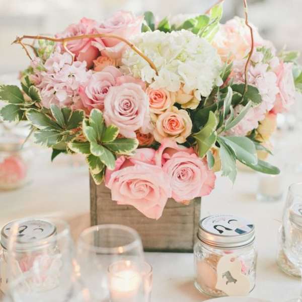 Pink and white rose centerpiece in a wooden box