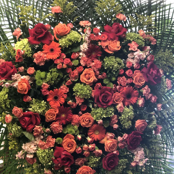Heart-shaped floral arrangement with roses and gerbera daisies