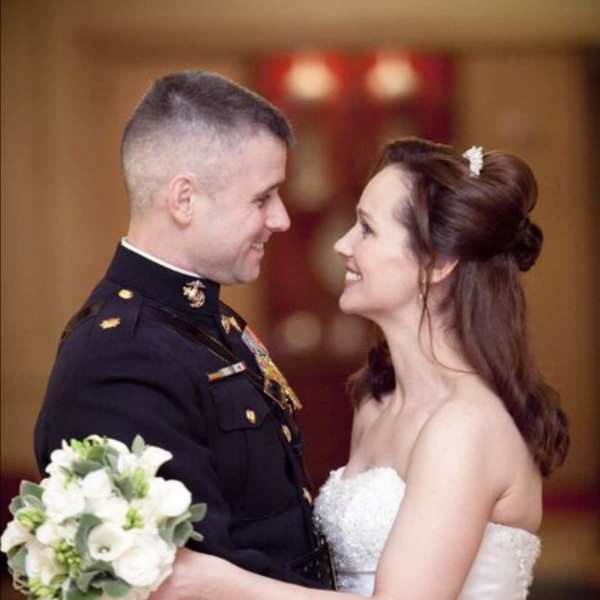 Bride and groom holding a white wedding bouquet