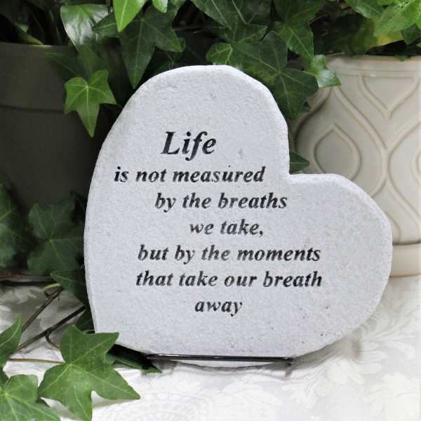 Heart-shaped memorial stone with a quote, surrounded by ivy