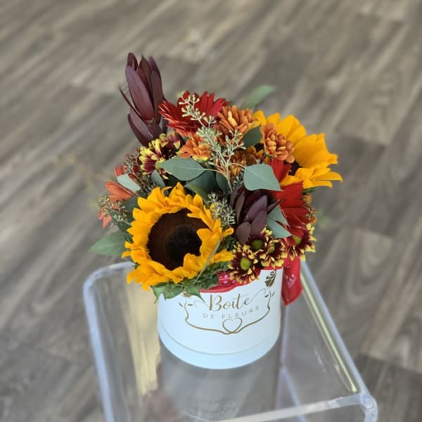 Sunflowers and mixed autumn flowers in a white hat box