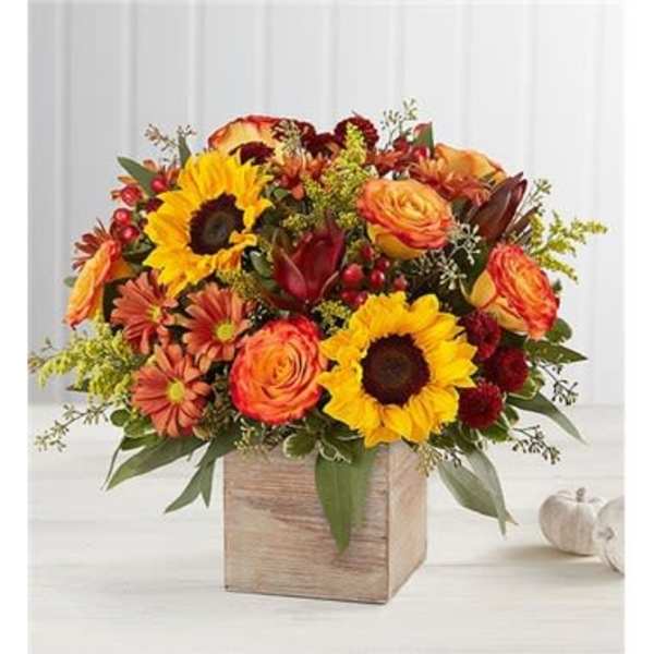 Autumn bouquet with sunflowers and orange roses in a wooden box