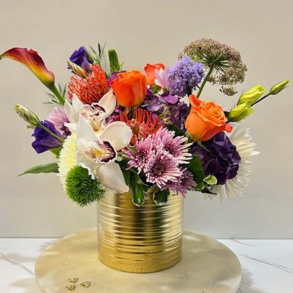 Colorful mixed bouquet in a gold metal vase