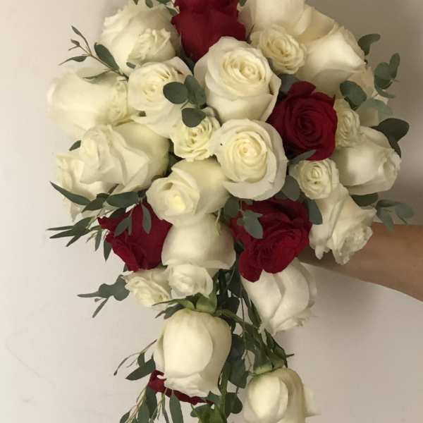 Bouquet of red and white roses with eucalyptus greenery