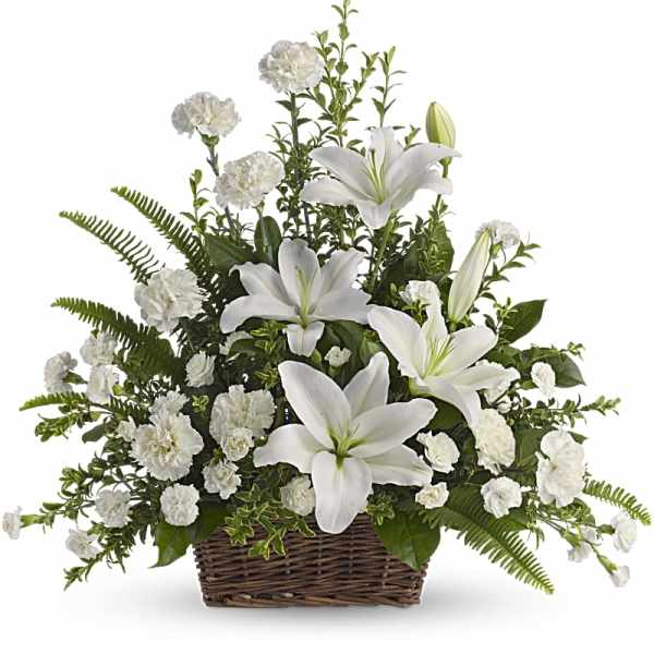White lilies and carnations in a wicker basket