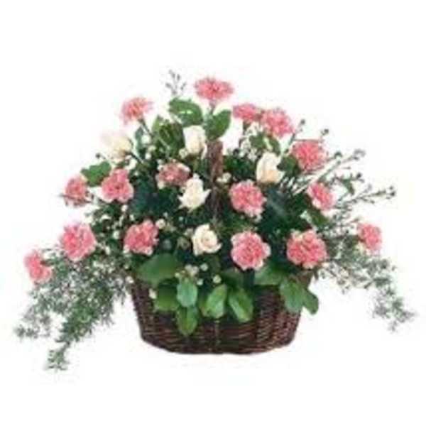 Pink and white flowers arranged in a wicker basket