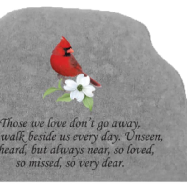 Gray memorial stone with a red cardinal and white flower
