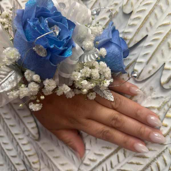 Blue rose wrist corsage with white baby's breath and silver ribbon