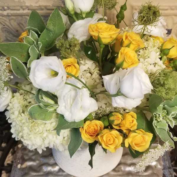 Yellow and white rose bouquet in a white vase