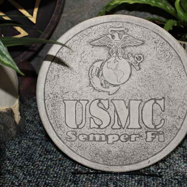 Round stone plaque engraved with the USMC emblem and text