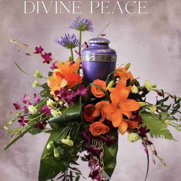 Purple urn surrounded by orange and magenta flowers
