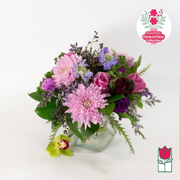 Pink and purple mixed bouquet in a clear glass vase