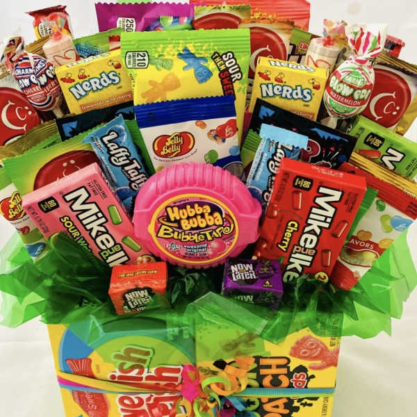 Candy bouquet with assorted sweets in a gift box and green tissue wrap