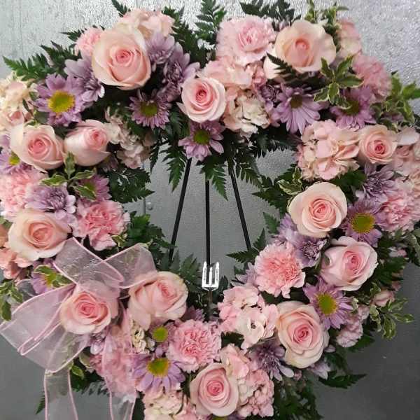 Heart-shaped floral wreath with pink roses and lavender flowers