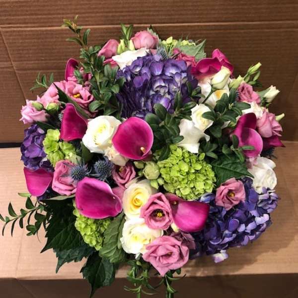 Mixed bouquet with pink calla lilies, purple hydrangeas, and white roses
