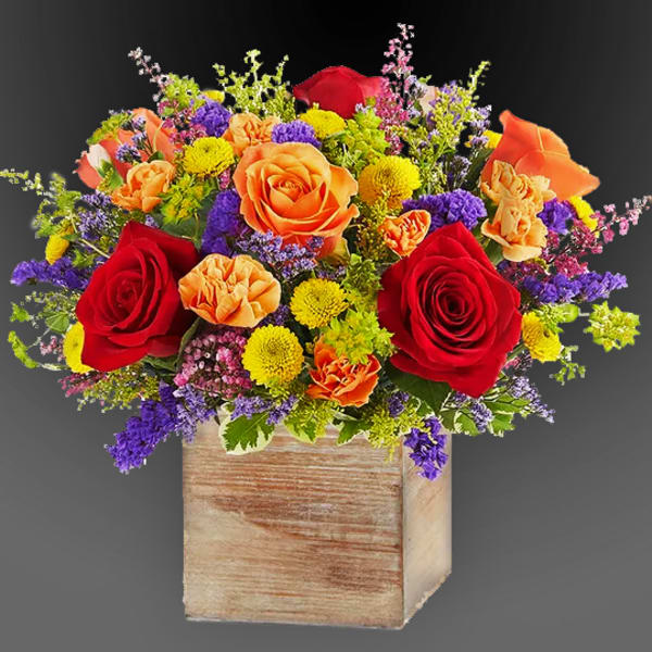 Bouquet of red, orange, yellow, and purple flowers in a wooden box