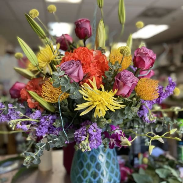 Colorful mixed bouquet in a blue patterned vase