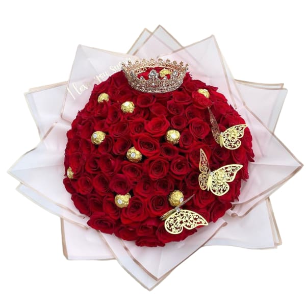 Round bouquet of red roses with a crown and gold butterfly accents