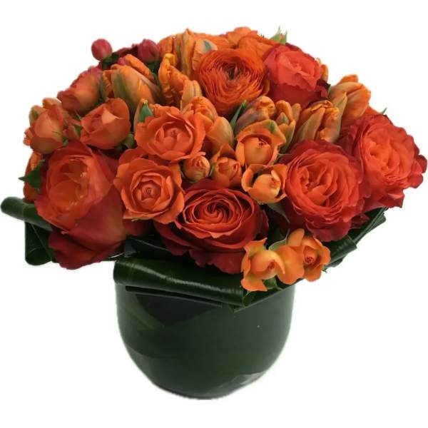 Orange bouquet of roses and tulips in a dark vase