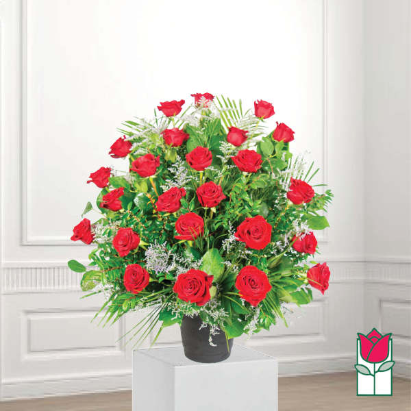 Red roses arranged in a black vase with greenery