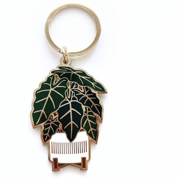 Leaf-shaped keychain with a gold ring on a white background