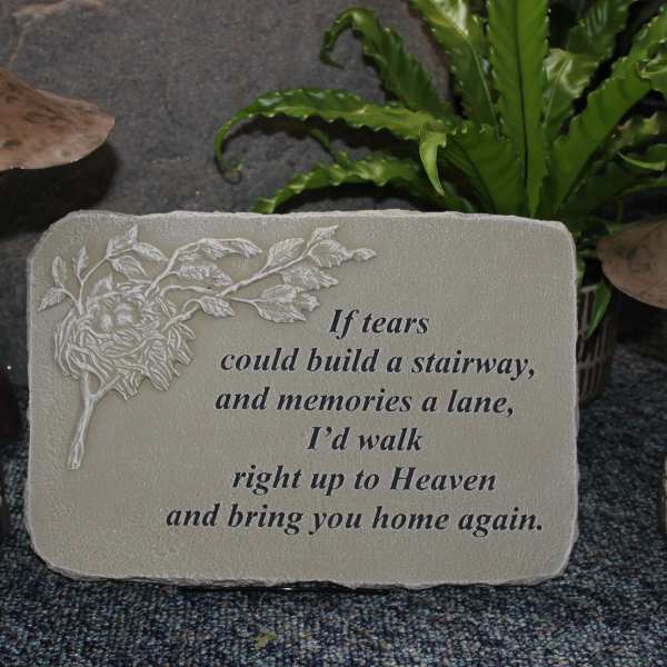 Memorial plaque with a sympathy quote between two mushroom ornaments