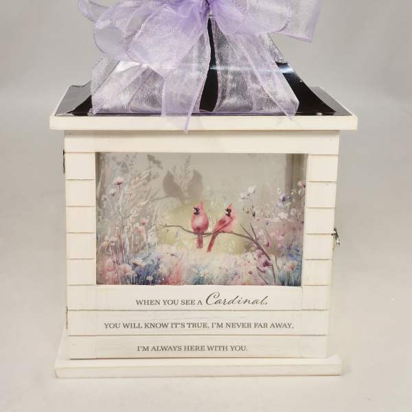 Decorative memorial lantern with a lavender bow and cardinal artwork