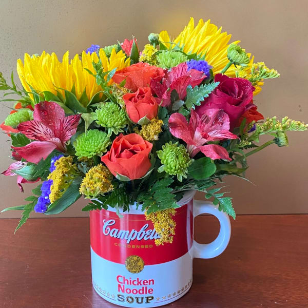 Mixed bouquet in a Campbell's soup mug vase