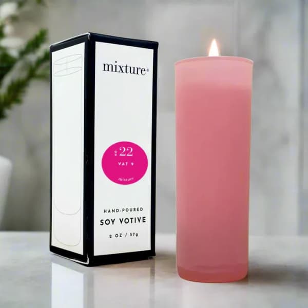Pink votive candle beside its box