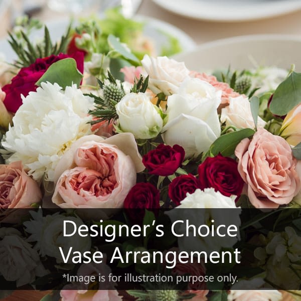 Mixed arrangement of white, blush, and red roses with peonies as a designer’s choice example.