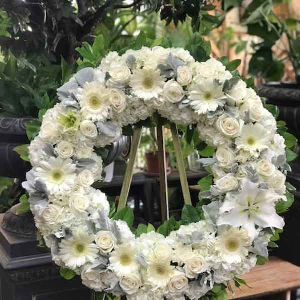 White floral wreath on a standing easel