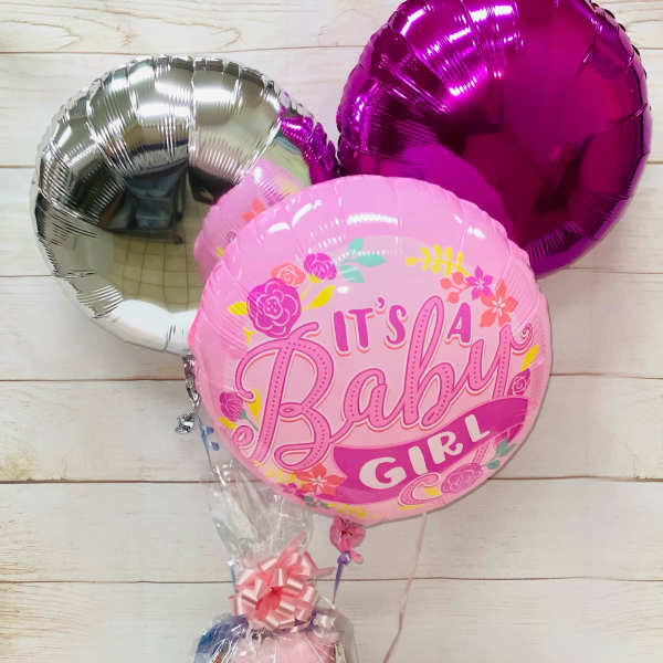 Baby girl balloon bouquet with pink gift basket wrapped in cellophane
