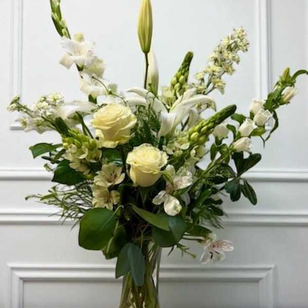 White floral arrangement in a clear glass vase