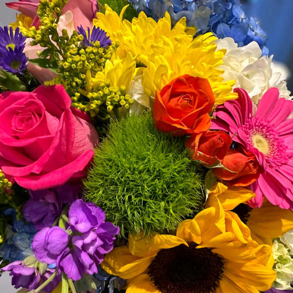 Colorful mixed bouquet with roses, sunflowers, and hydrangeas