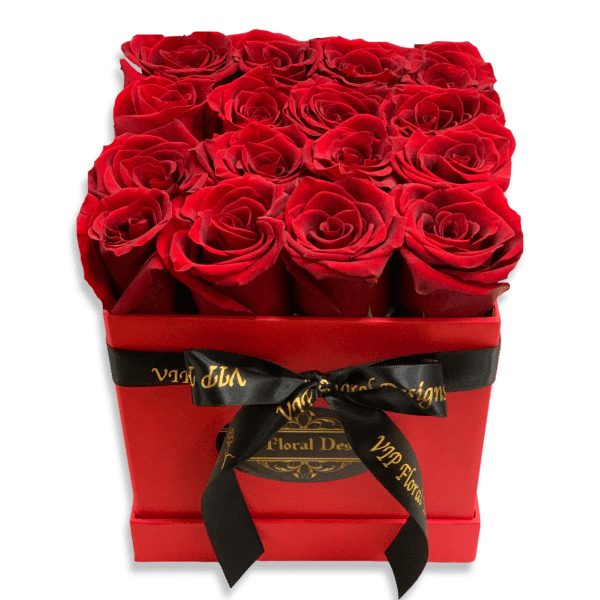Red roses arranged in a square red box with a black ribbon