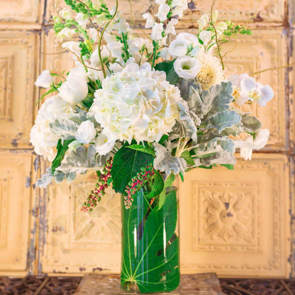 White floral arrangement in a clear glass vase