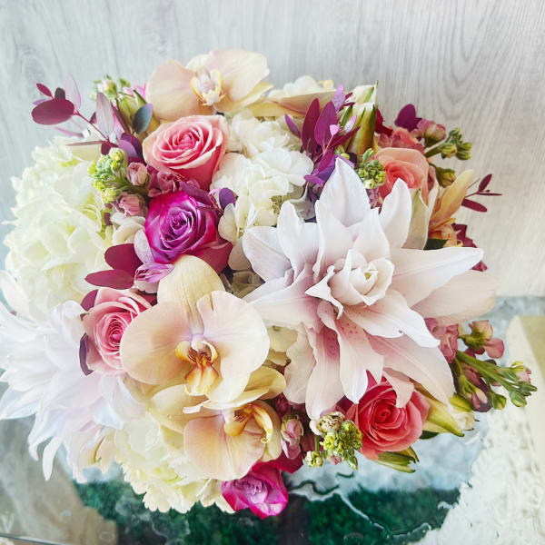 Bouquet of pink roses, white hydrangeas, and pale orchids