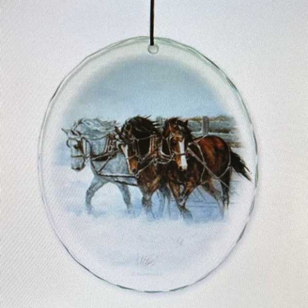 Round glass ornament with a painted horse scene