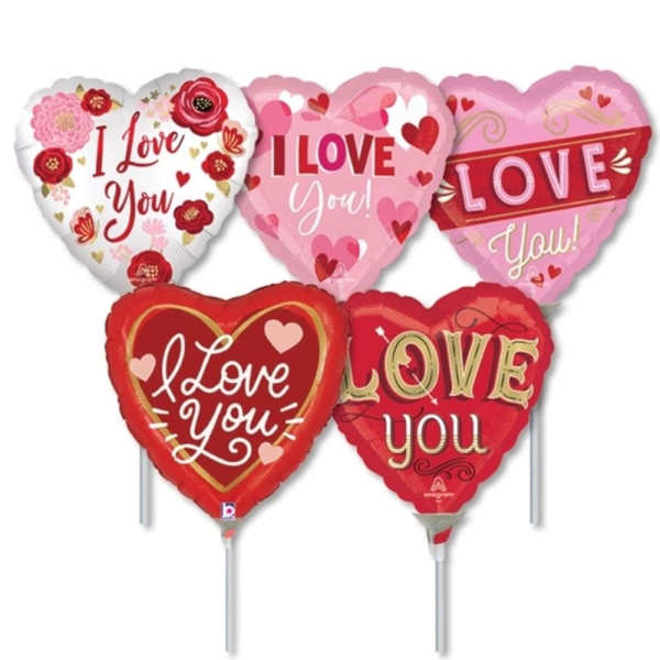 Five heart-shaped "I love you" balloons in pink, red, and white