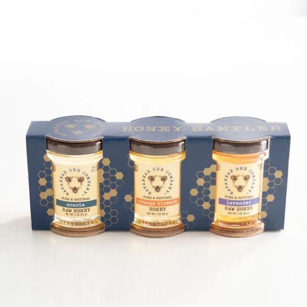 Three jars of honey in a blue sampler box