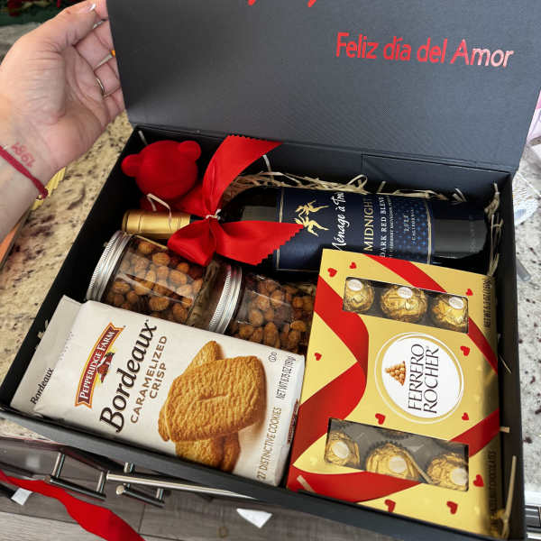 Gift box with wine, chocolates, cookies, and a small plush bear