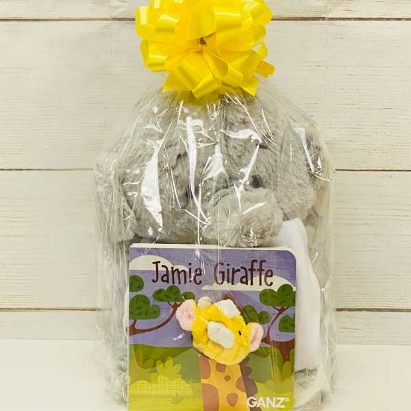 Cellophane-wrapped gift set with gray plush toy and 'Jamie Giraffe' book topped with a yellow bow