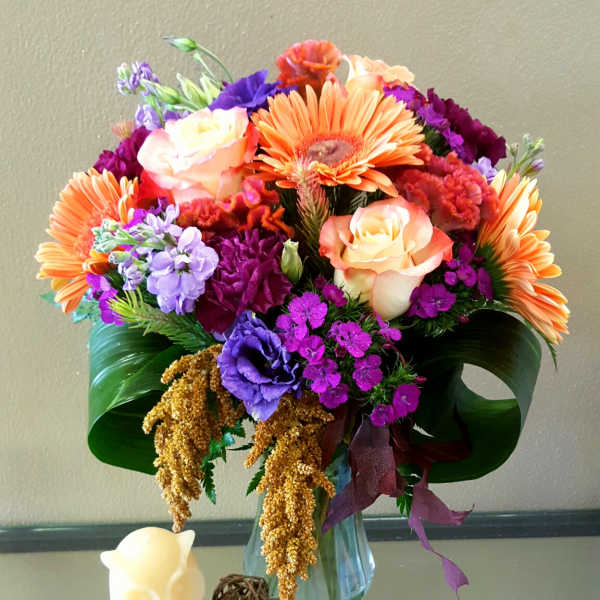 Colorful bouquet of mixed flowers in a clear glass vase