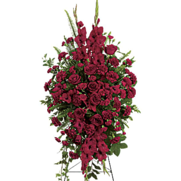 Tall standing spray of dark red flowers on a metal easel