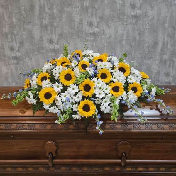 Sunflower and white daisy casket spray with blue accents