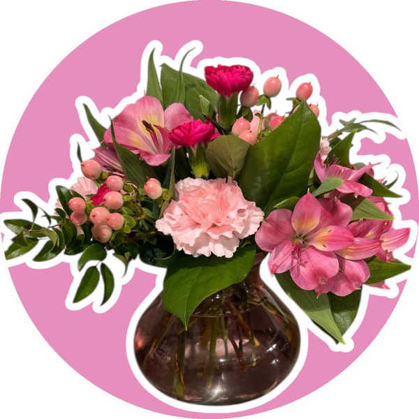 Pink flowers arranged in a round glass vase
