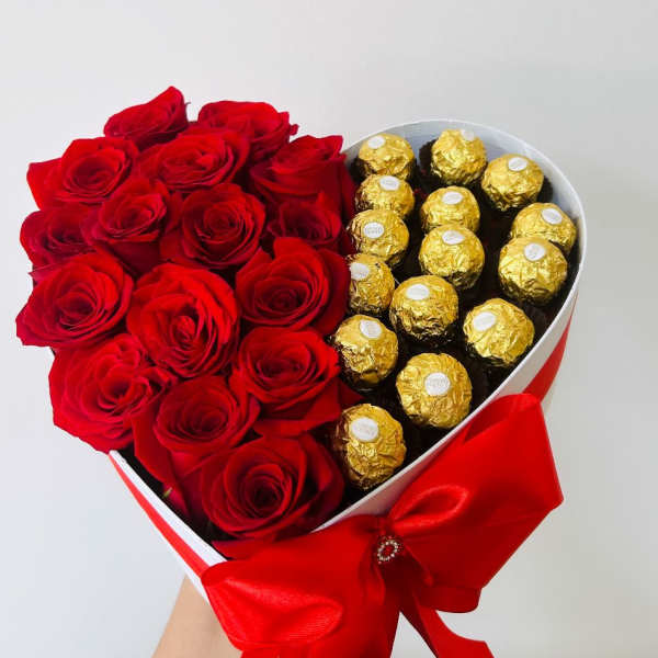 Heart-shaped box with red roses and gold-wrapped chocolates
