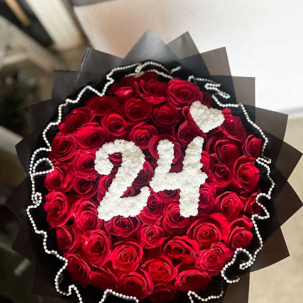 Bouquet of red roses with white "24" decoration and black wrap